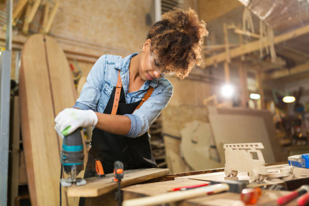 istock Young woman doing woodwork in a workshop 973374570