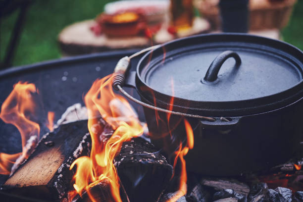 istock Cooking Chili Con Carne in Dutch Oven over Logfire 973374870