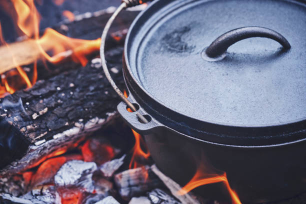 istock Cooking Chili Con Carne in Dutch Oven over Logfire 973374876