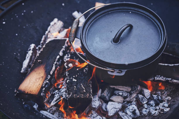 istock Cooking Chili Con Carne in Dutch Oven over Logfire 973374880