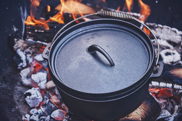 istock Cooking Chili Con Carne in Dutch Oven over Logfire 973374886