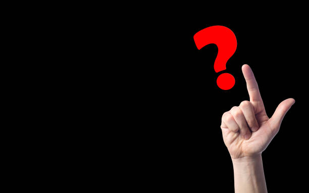 istock finger points to question marks on black isolated background. concept of the question. the problem of choice, meditation, a difficult question 973377760
