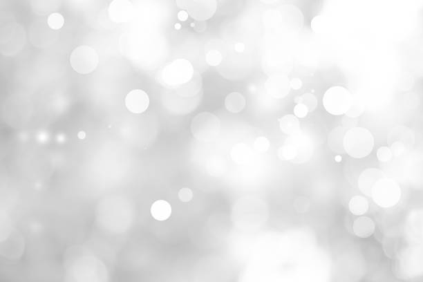 istock white blurred backdrop of nature, circle white wallpaper, gray bokeh background 973377934