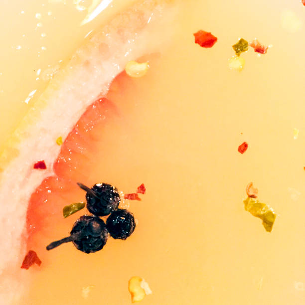 Closeup of fancy drink in martini glass with peppercorns