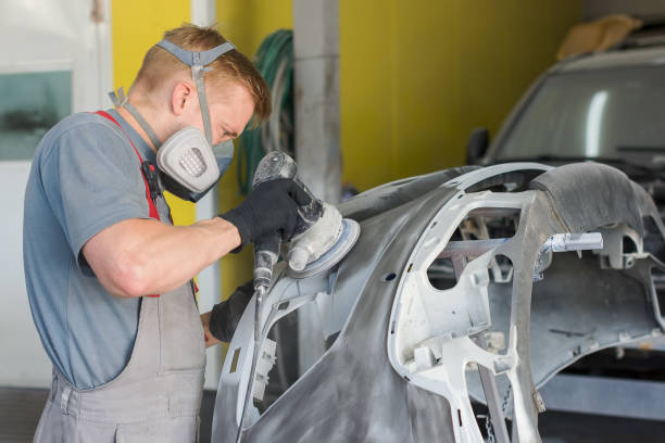 istock Auto mechanic repairs the car body part 973378992