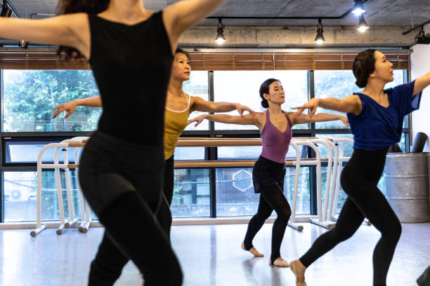 istock Group of korean women learning how to dance at class in a studio 973379040