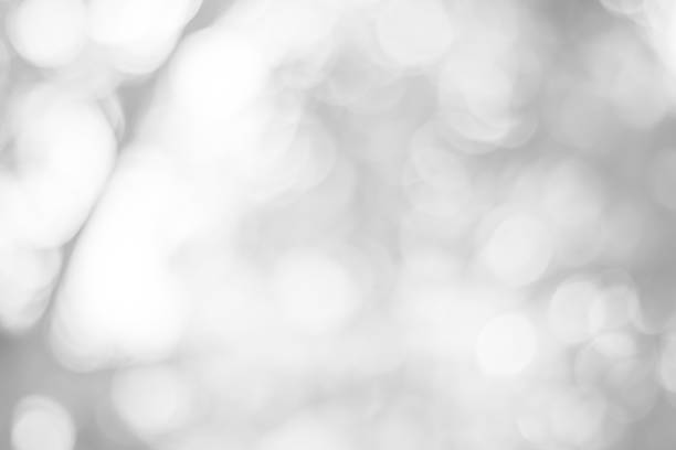 istock white blurred backdrop of nature, circle white wallpaper, gray bokeh background 973379144