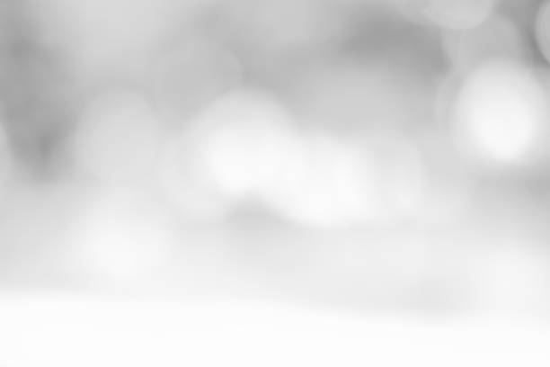 istock white blurred backdrop of nature, circle white wallpaper, gray bokeh background 973387424