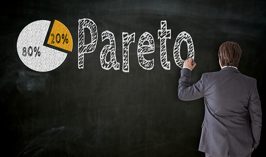 Businessman paints Pareto on blackboard concept.