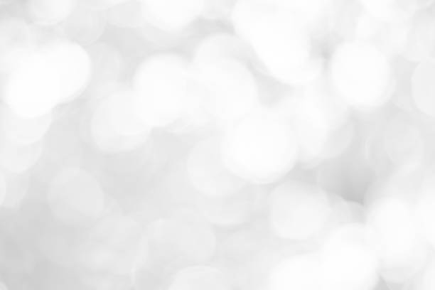 istock white blurred backdrop of nature, circle white wallpaper, gray bokeh background 973388250