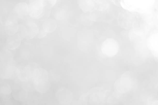 istock white blurred backdrop of nature, circle white wallpaper, gray bokeh background 973399240