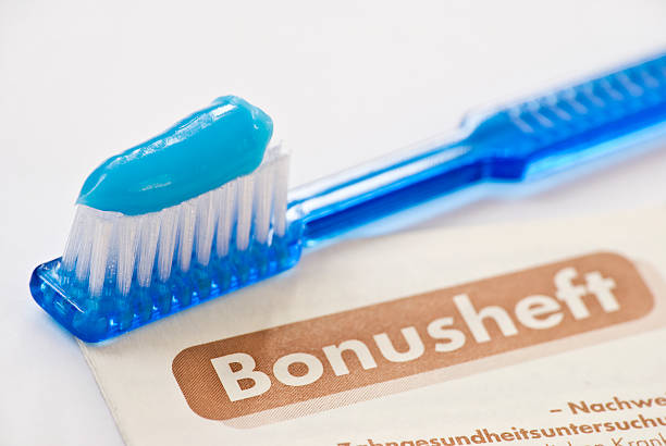 Two toothbrushes in a glass. One toothbrush with protective cap. Dental care and health concept. Portrait capture