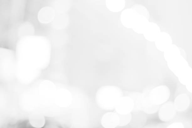 istock white blurred backdrop of nature, circle white wallpaper, gray bokeh background 973410956