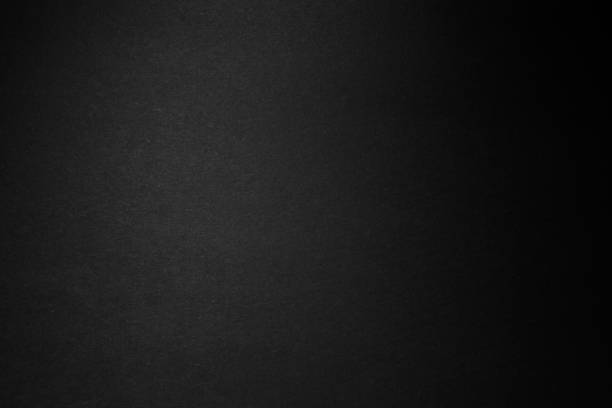 istock black paper texture or background with spotlight, dark wall backdrop wallpaper, dark tone. 973411530