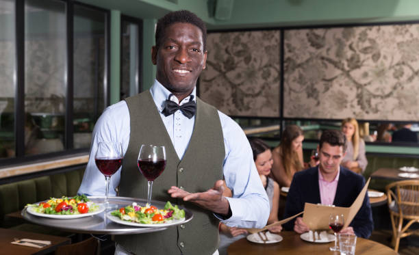 istock African American waiter with serving tray 973415166