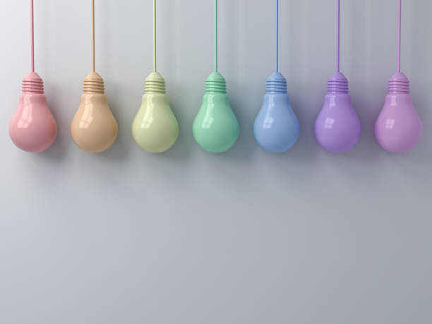 istock Colorful hanging light bulbs on white wall background 3D rendering 973415662