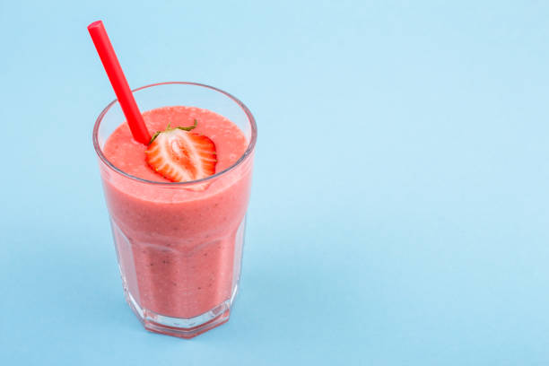 istock fresh strawberrysmoothie or milkshake on a delicately blue background 973415696