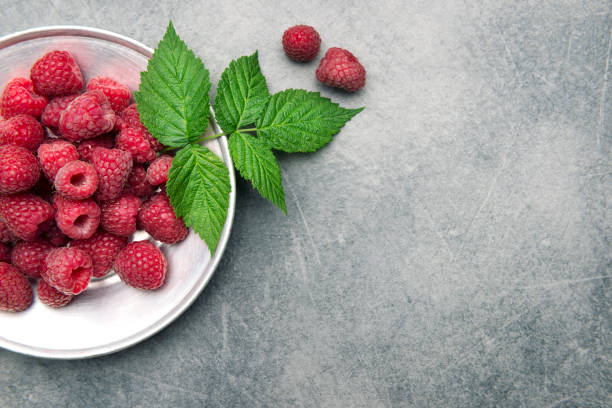 Fresh raspberries and green leaves