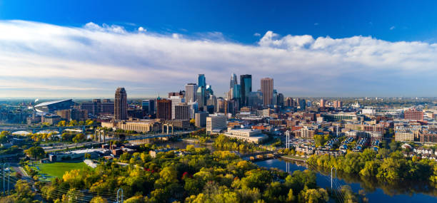 Minneapolis Skyline Aerial With River And Golden Trees During Autumn Minneapolis skyline aerial / elevated view with the Mississippi River, Third Avenue Bridge, and a park with golden colored trees during Autumn. minneapolis stock pictures, royalty-free photos & images