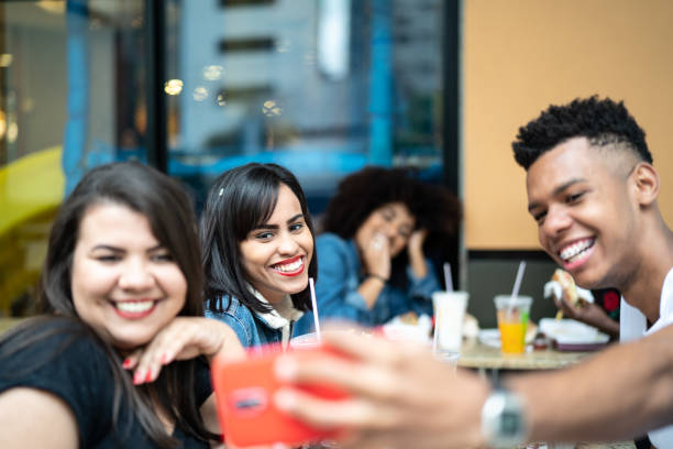 istock Group of young people taking a selfie in a restaurant 973422430