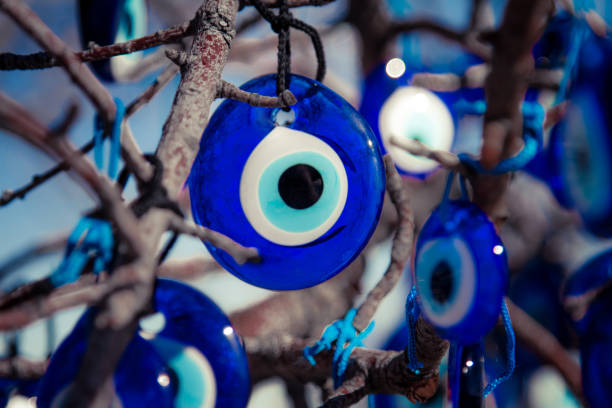 hanging on the tree evil eye bead - evil eye beads imagens e fotografias de stock