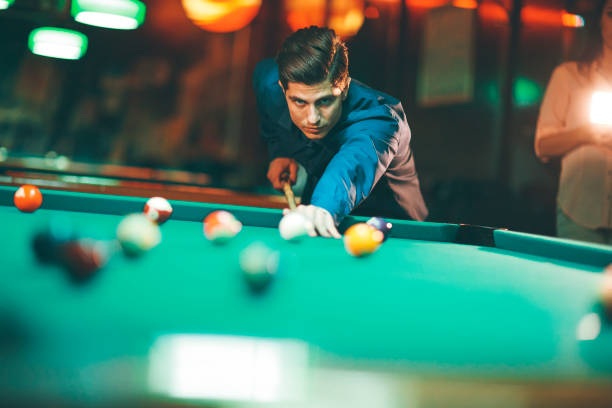 Young man playing pool stock photo
