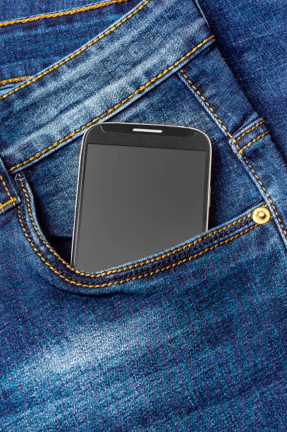 istock Smartphone in back pocket of jeans. 973427782