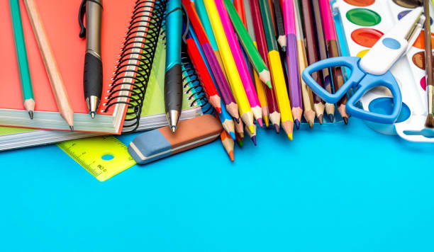 istock School supplies on blue background. Close up. 973428278