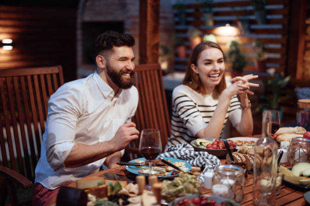 istock Happy friends having fun an drinking wine 973430318