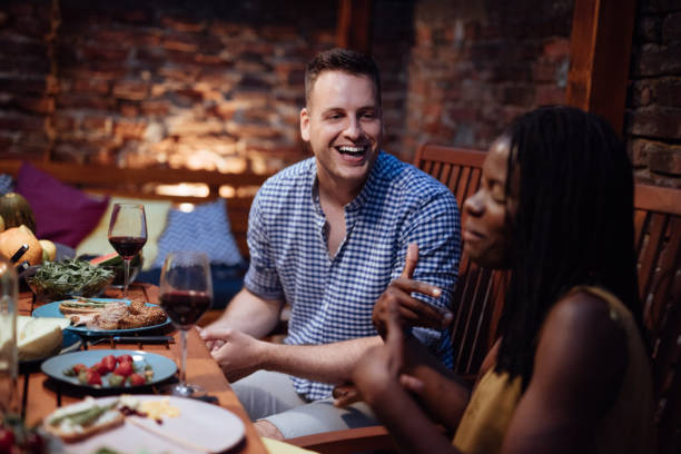 istock Happy friends having fun an drinking wine 973431402
