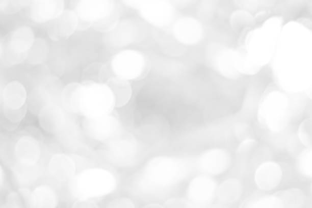 istock white blurred backdrop of nature, circle white wallpaper, gray bokeh background 973432276