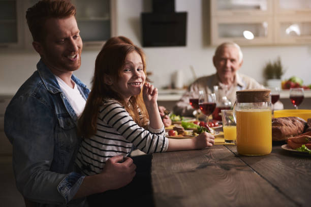 istock Happy kid and parent at table 973432558