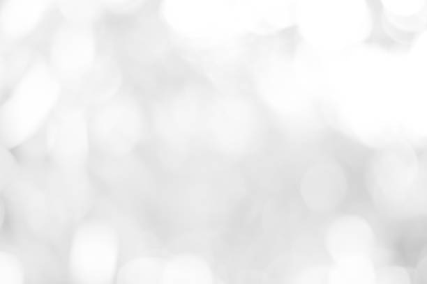 istock white blurred backdrop of nature, circle white wallpaper, gray bokeh background 973433546