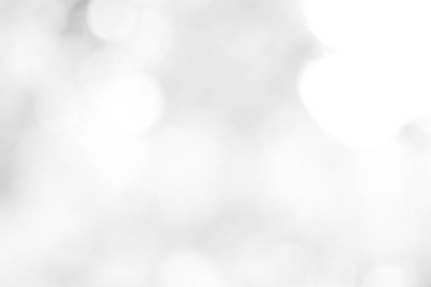 istock white blurred backdrop of nature, circle white wallpaper, gray bokeh background 973434872