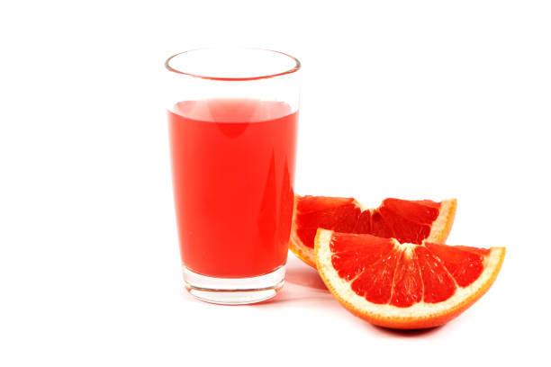 istock Fresh grapefruit juice with mint in a glass cup isolated on white background. Grapefruit fresh and juice on a white background, view of the shu, cospore space 973434908