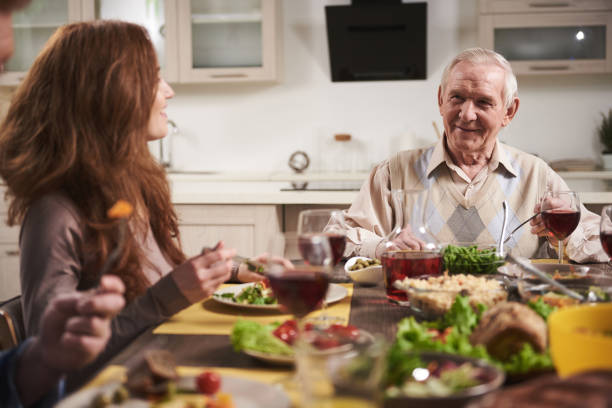 istock Senior man at table by woman 973435010