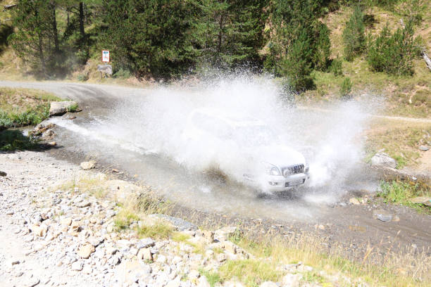 istock Off-road car crossing river 973439484
