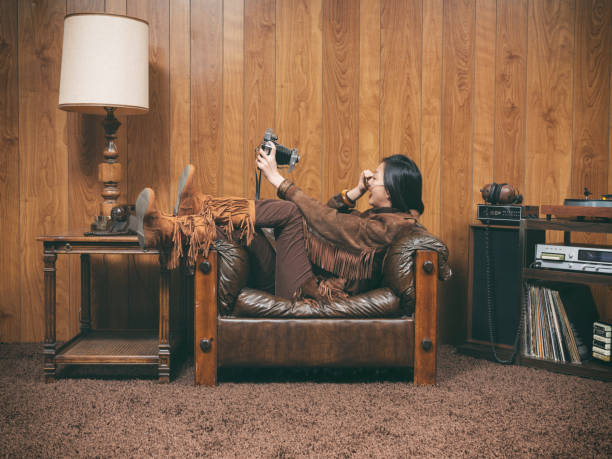 Retro 1970's Girl A young Asian woman wearing retro-styled 1970's clothing. Both the model and set are styled to portray a teenager/young adult from 1976 with period correct clothing, furniture, and props. wood paneling retro stock pictures, royalty-free photos & images