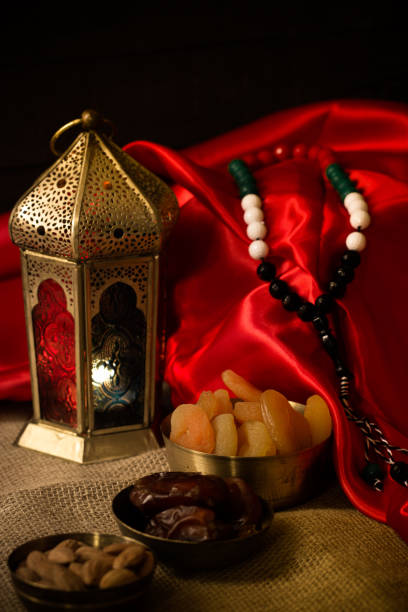 istock Ramadan kareem with premium dates,nuts and arabic coffee. Festive still life with oriental ramadan lantern and iftar food concept. 973443178