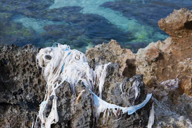 The Old Fishnet on the Rock with Sea on Background.