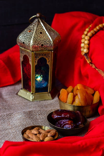 istock Ramadan kareem with premium dates,nuts and arabic coffee. Festive still life with oriental ramadan lantern and iftar food concept. 973452346