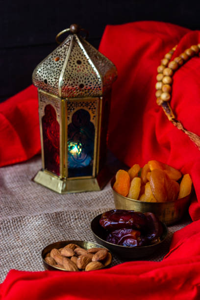 istock Ramadan kareem with premium dates,nuts and arabic coffee. Festive still life with oriental ramadan lantern and iftar food concept. 973452348