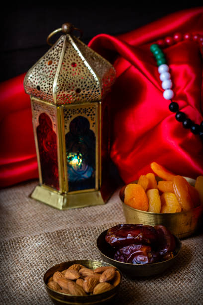 istock Ramadan kareem with premium dates,nuts and arabic coffee. Festive still life with oriental ramadan lantern and iftar food concept. 973452678