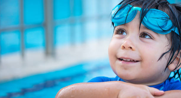 istock Happy boy enjoying summer time in swimming pool 973456986