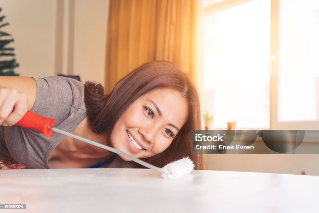 Happy Asian woman painting and smiling Adult Stock Photo