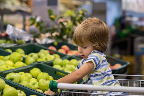 istock little boy in grocery store 973461780