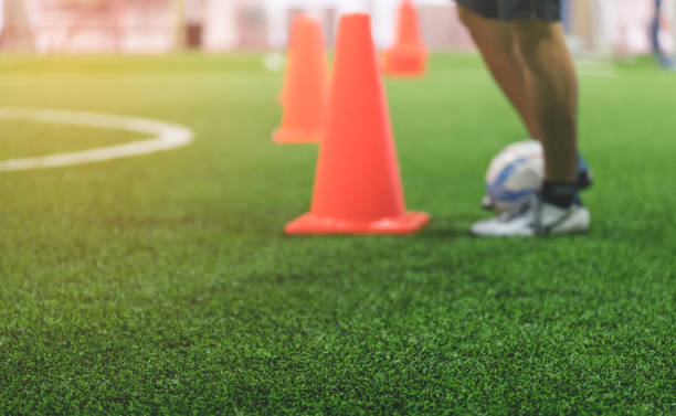 istock Indoor soccer training field blur abstract for background 973464480