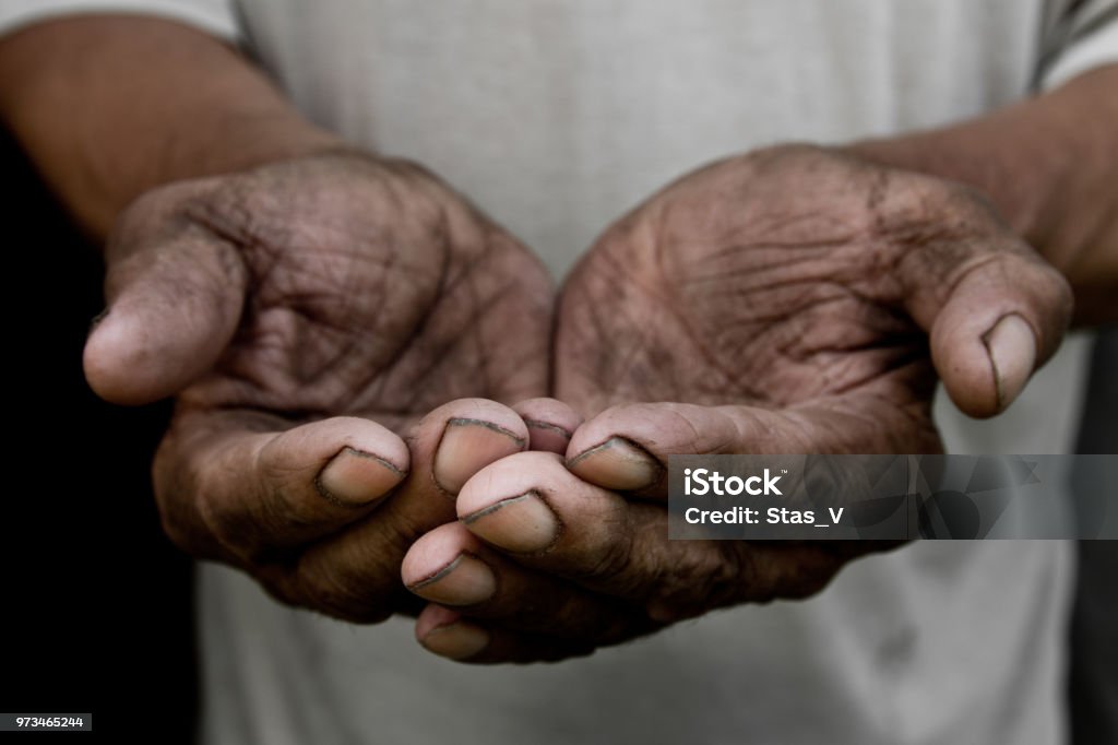 The poor old man's hands beg you for help. The concept of hunger or poverty. Selective focus. Poverty in retirement. Alms Begging - Social Issue Stock Photo