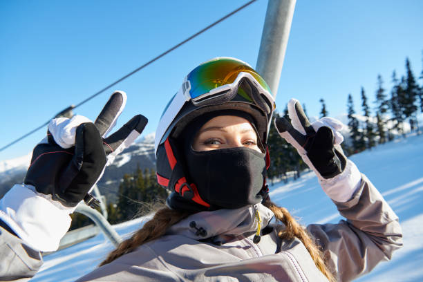 istock Young woman snowboarder over beautiful background 973470362