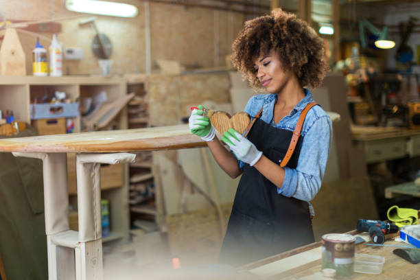istock Young woman doing woodwork in a workshop 973470670